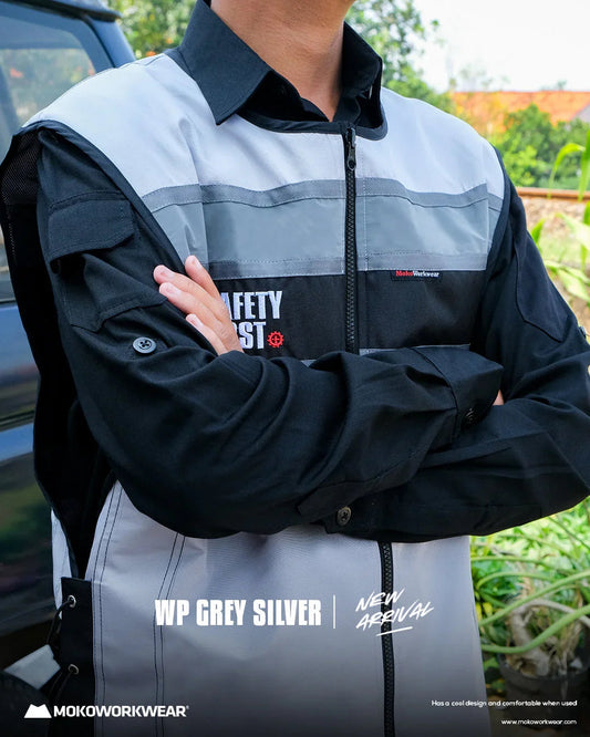 Close-up of person wearing WP Grey Silver workwear vest with black shirt, outdoor setting