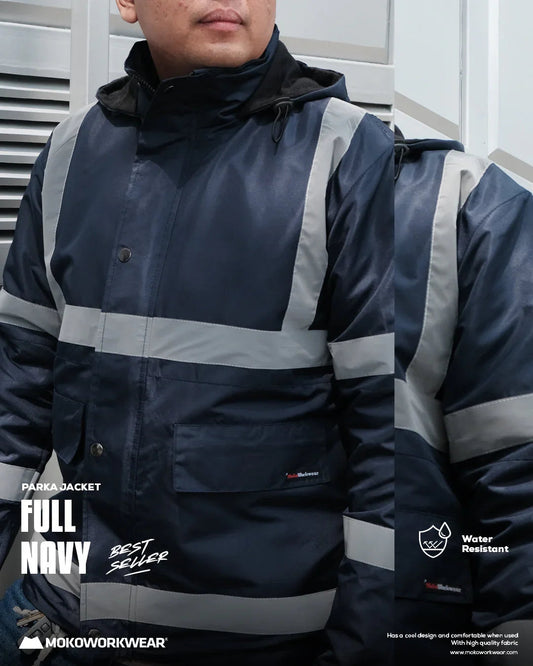 Man wearing full navy blue reflective work parka jacket, water resistant, urban background